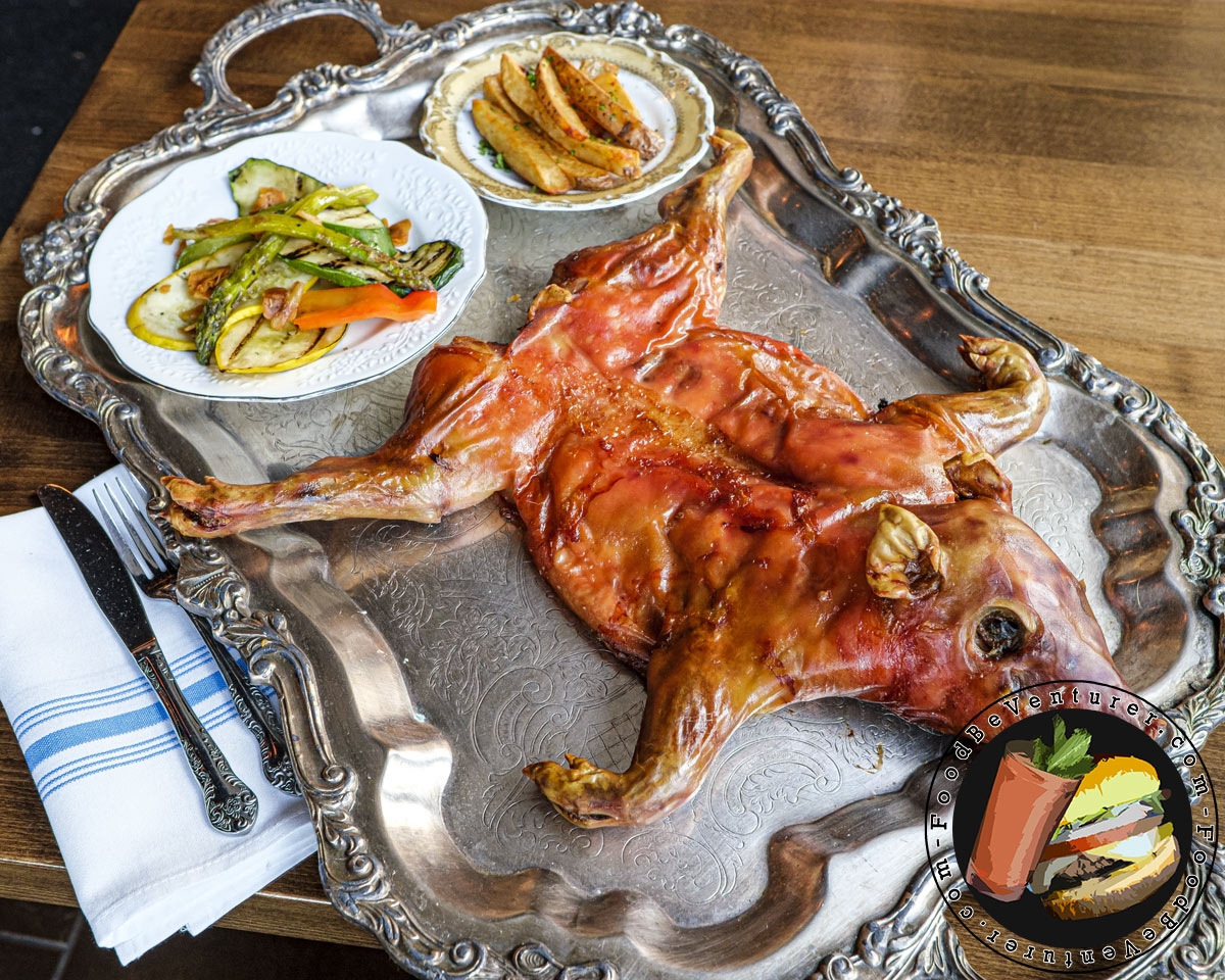 small roast pig and sides on a tray